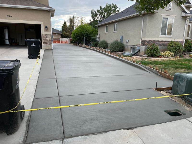 Newly poured concrete driveway with caution tape.