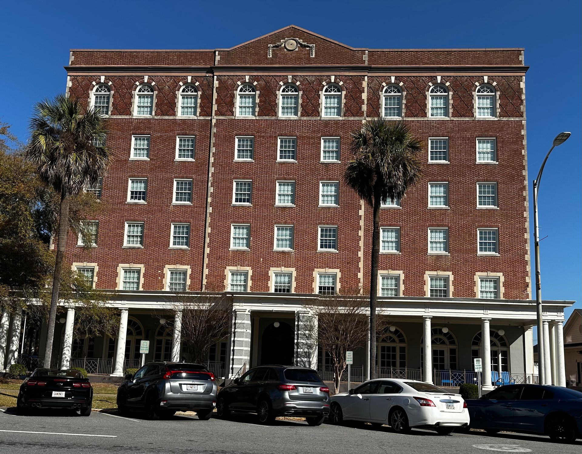 a large brick building with cars parked in front of it