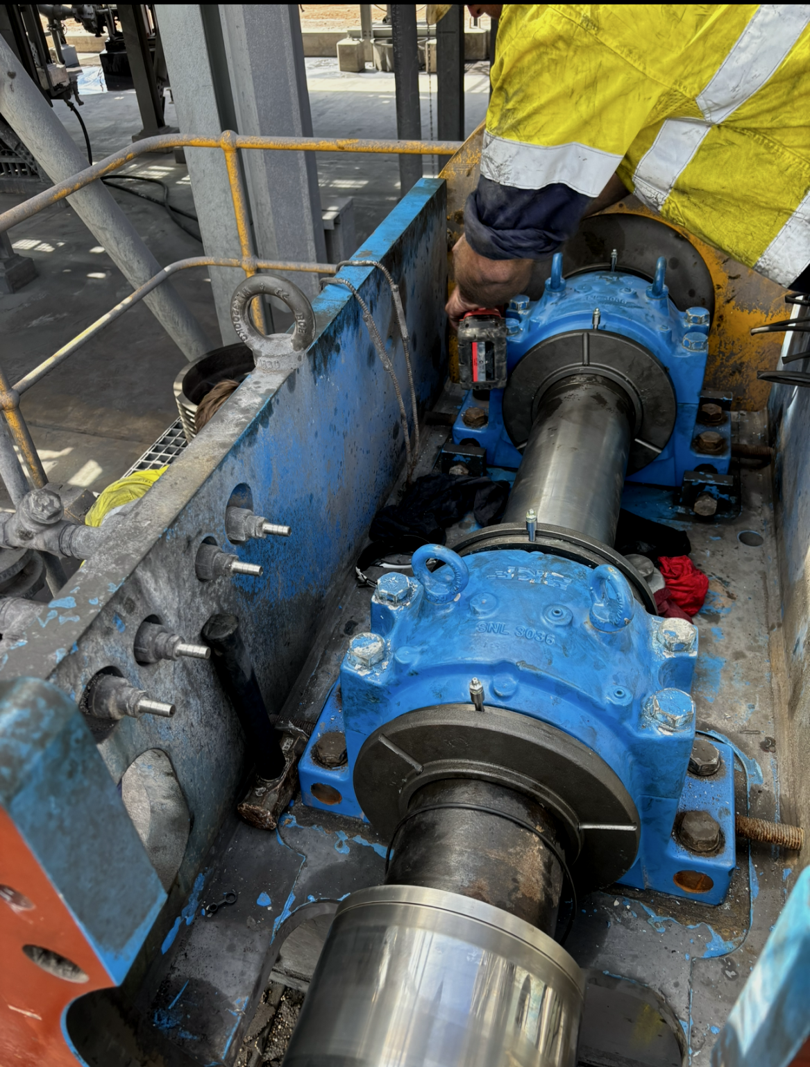 A man is working on a machine in a factory.