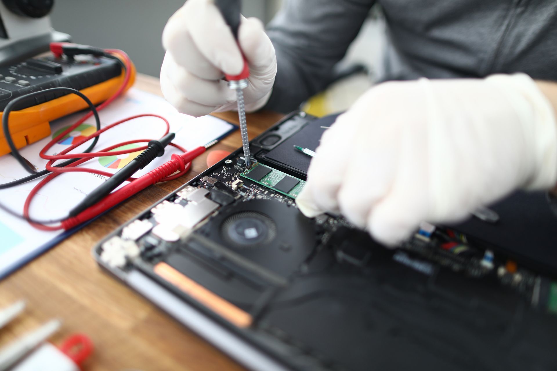 A person performing a laptop repair A person performing a laptop repair