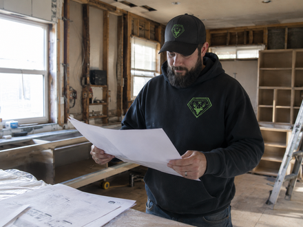 Jason Bowman reviewing plans at a kitchen renovation jobsite