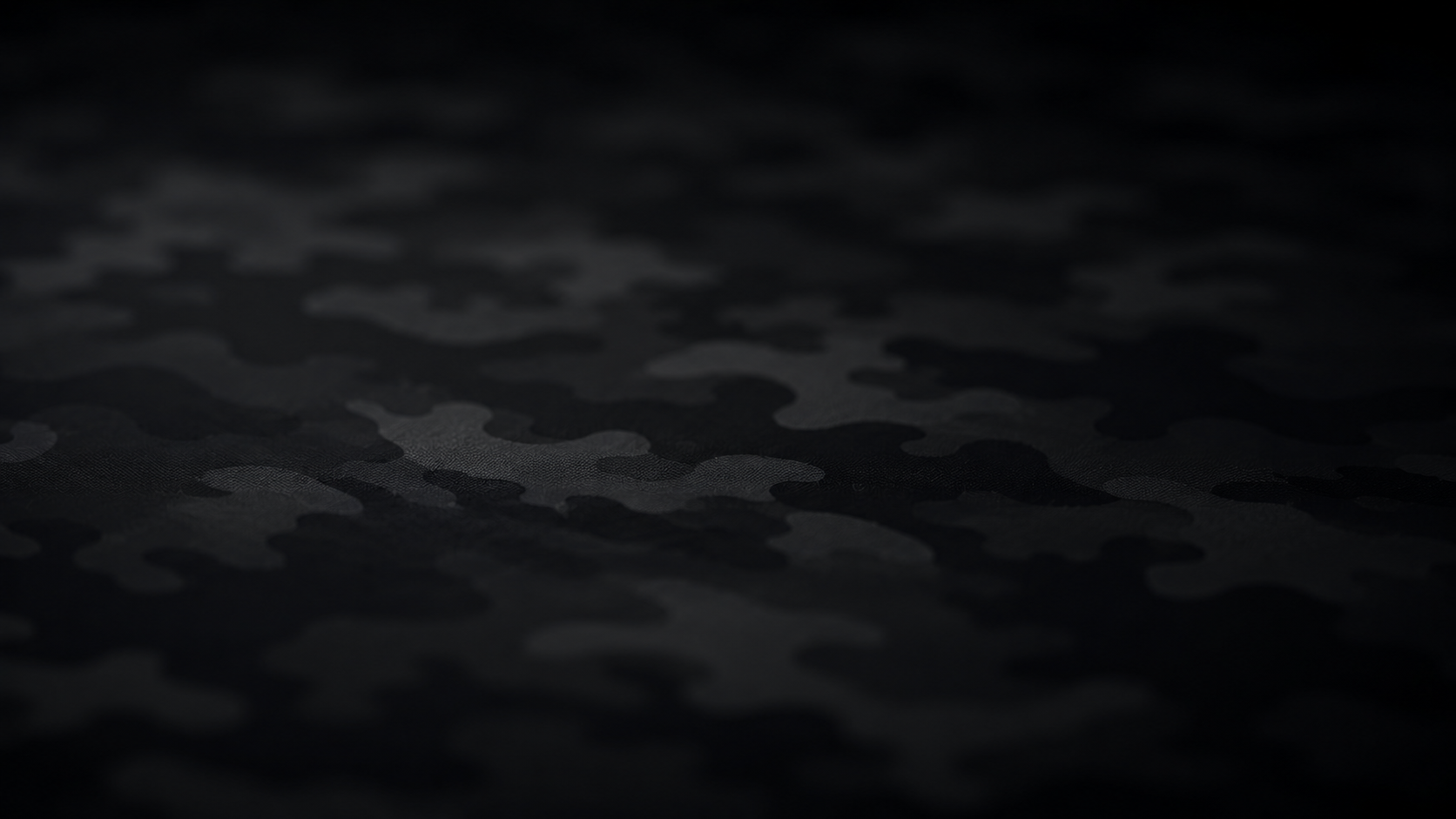Dark camouflage-patterned fabric with a wavy horizontal band across the center