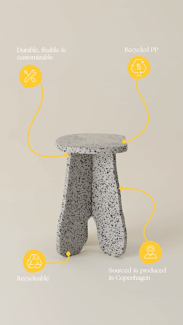 A stool with a yellow line going through it is sitting on a table.