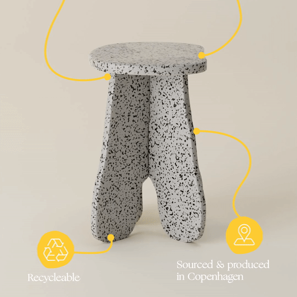 A stool made of recycled plastic is sitting on a table.