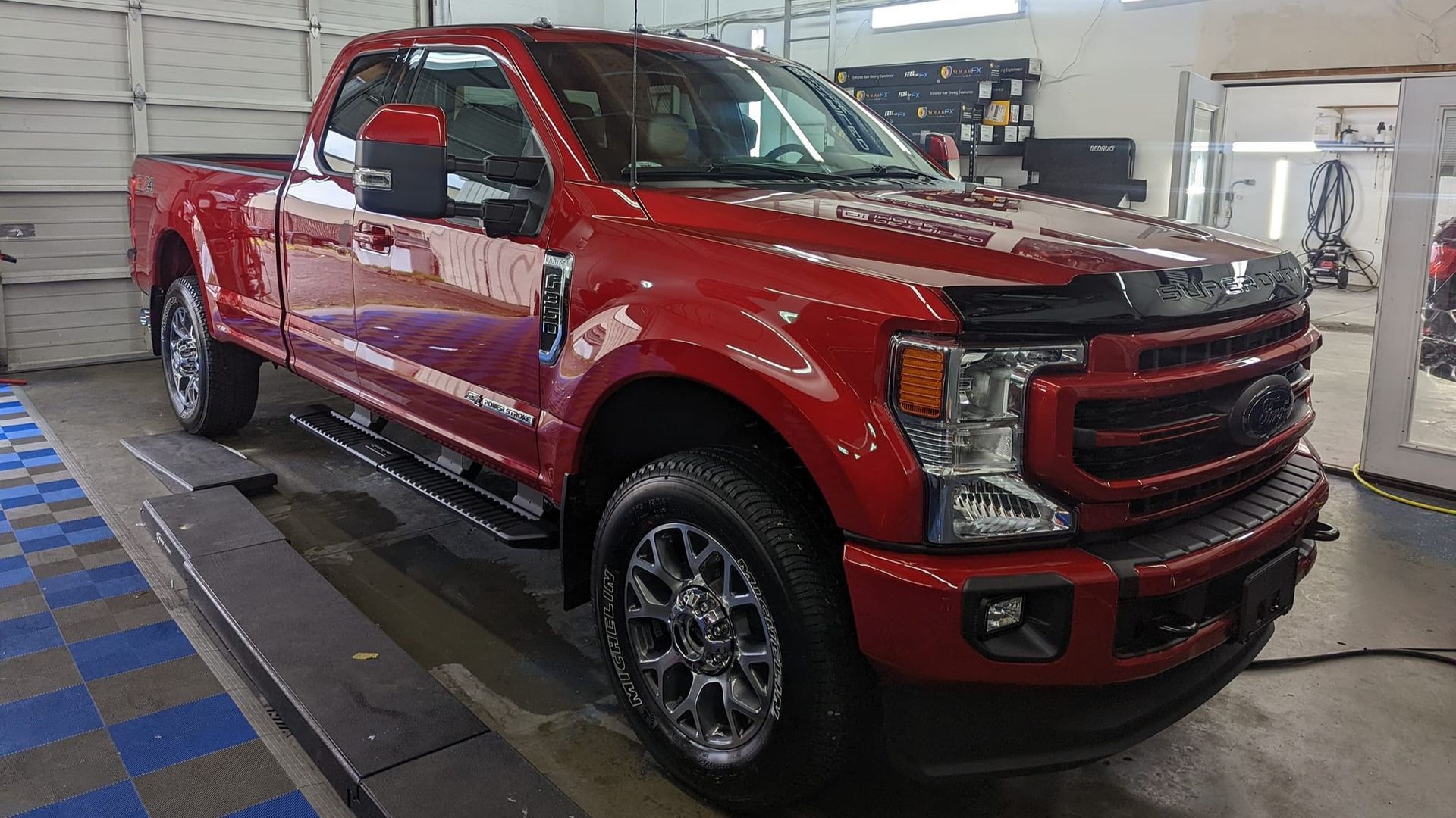 A red ford truck is parked in a garage.