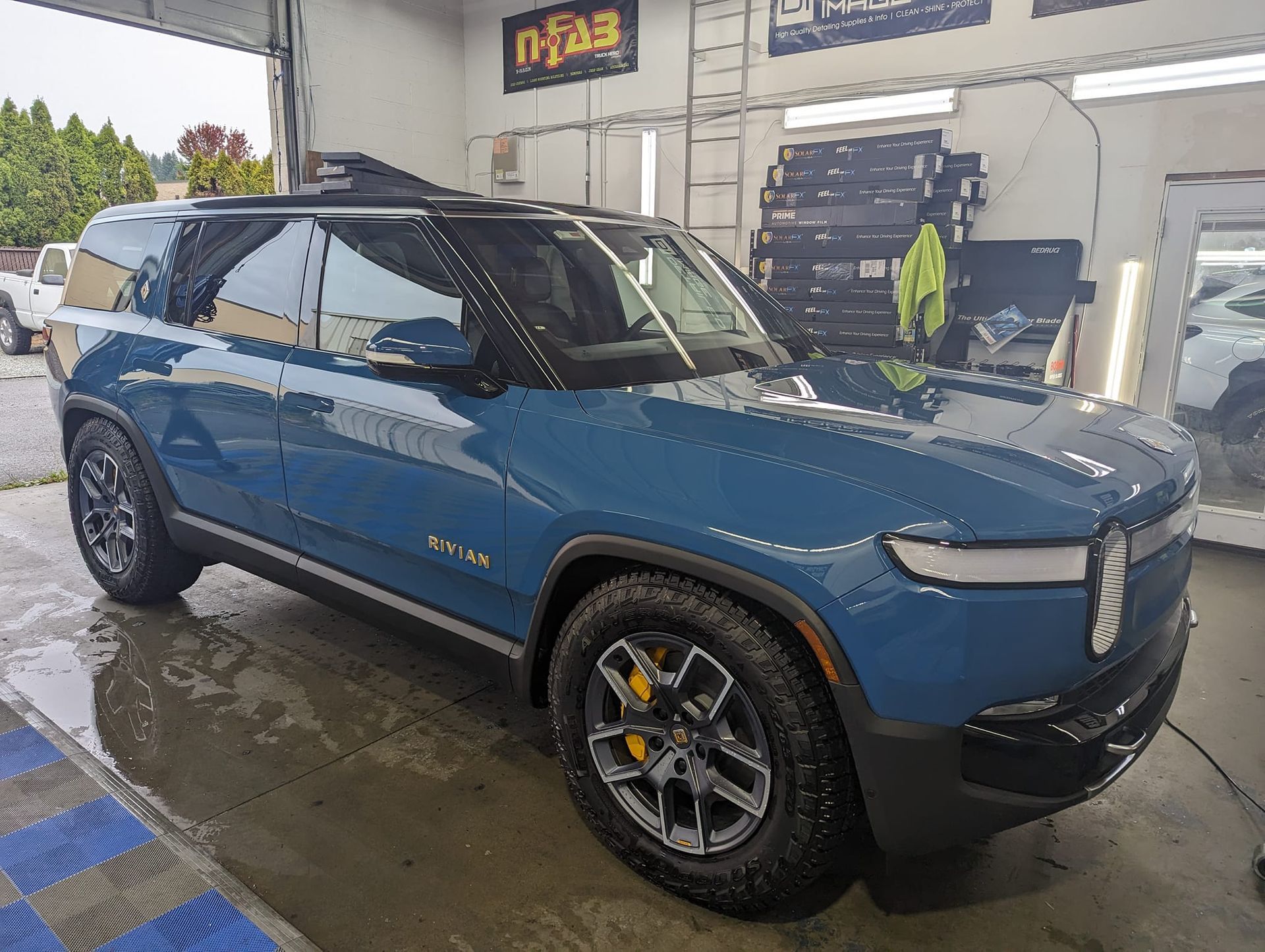 A blue suv is parked in a garage.
