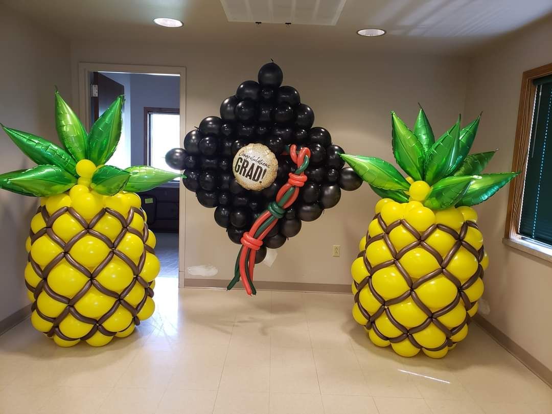 Custom pineapples and extra large graduation cap. 