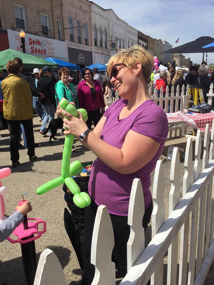 Balloon twister twisting an animal.
