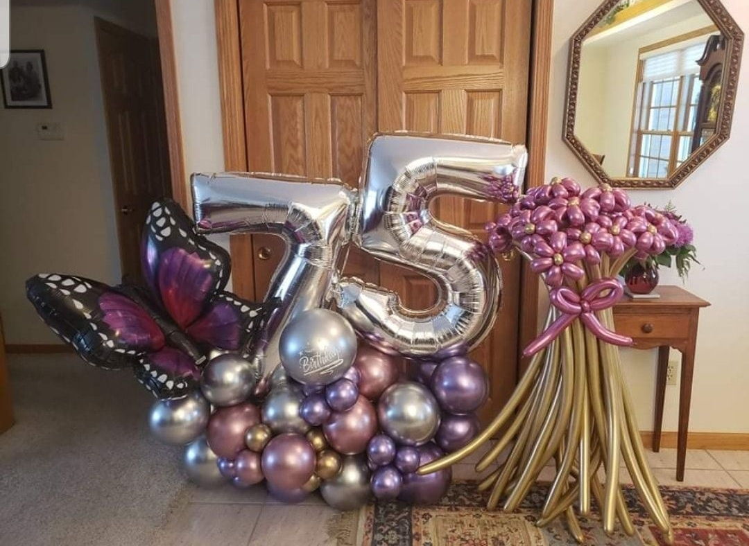 75th celebration balloon marquee with large foil butterfly and balloon floral arrangement. Shades of purples, rose gold and silver. 