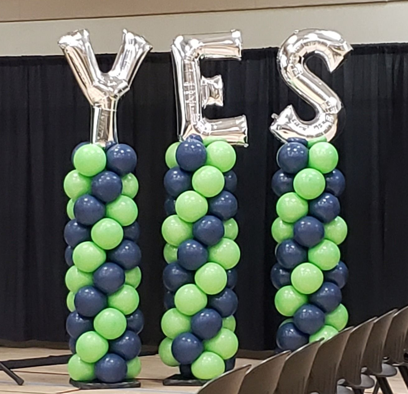 Classic column, swirl style with foil letter toppers to spell, YES. Lime green and navy colors. 