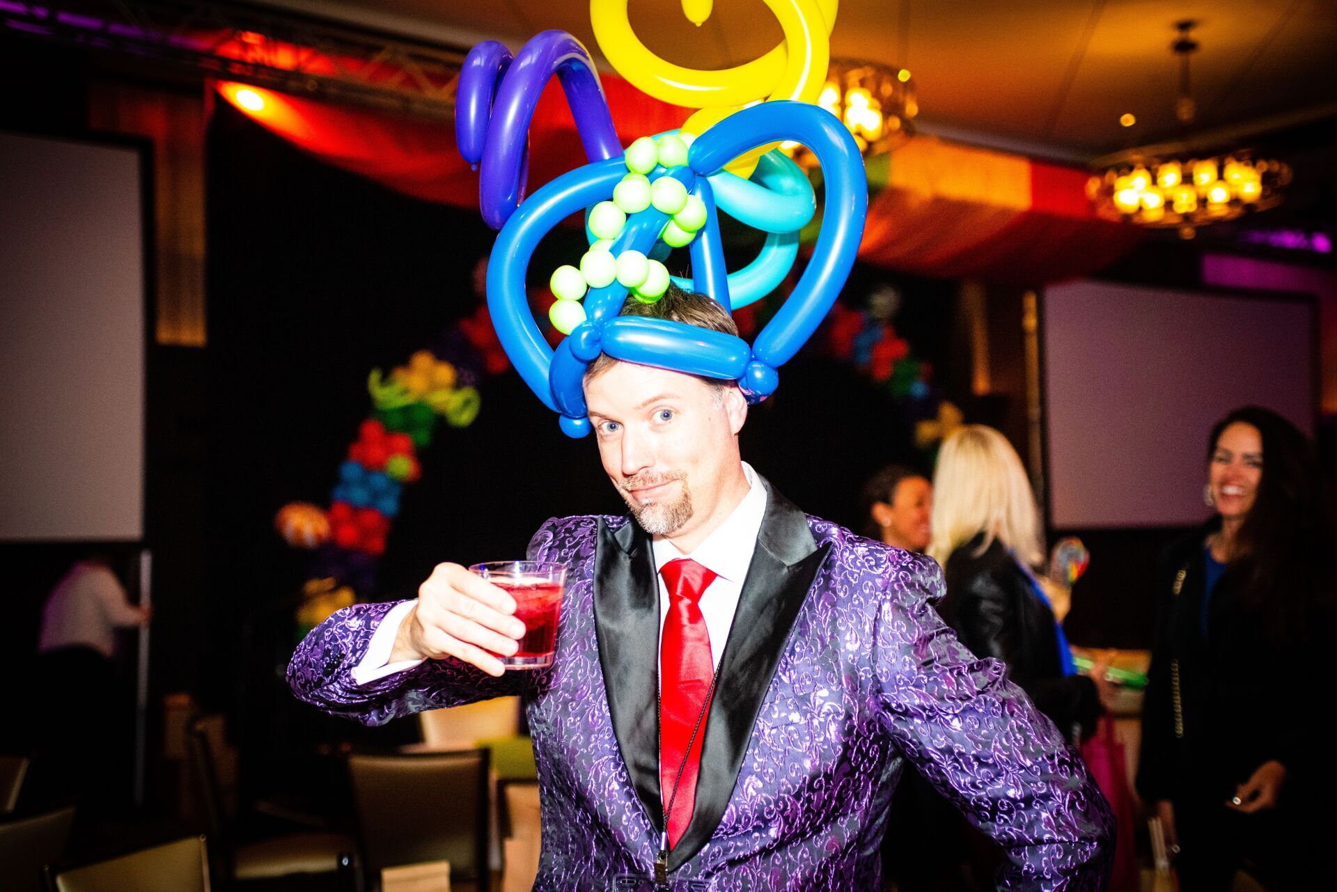 Balloon twisted crown headpiece on man.