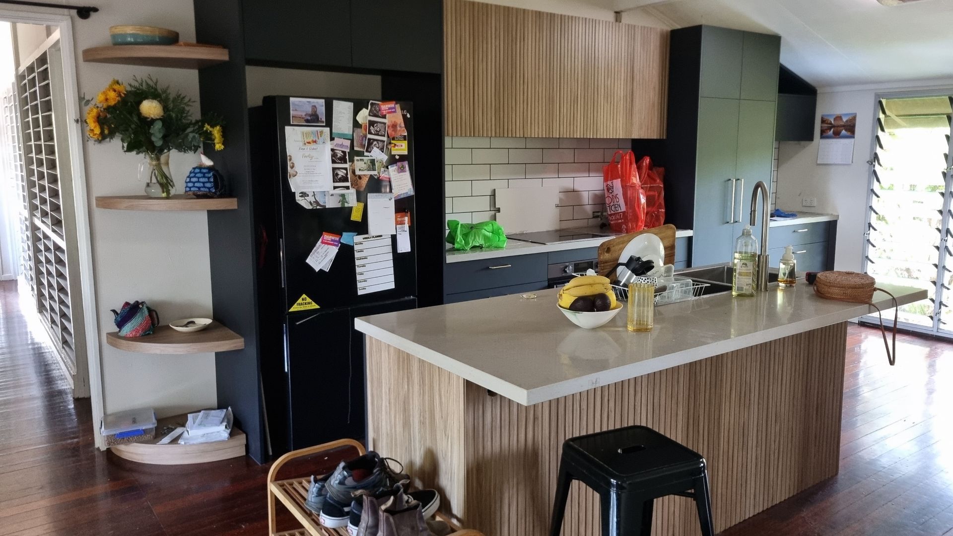 Kitchen with black appliances, wooden cabinets, and an island.