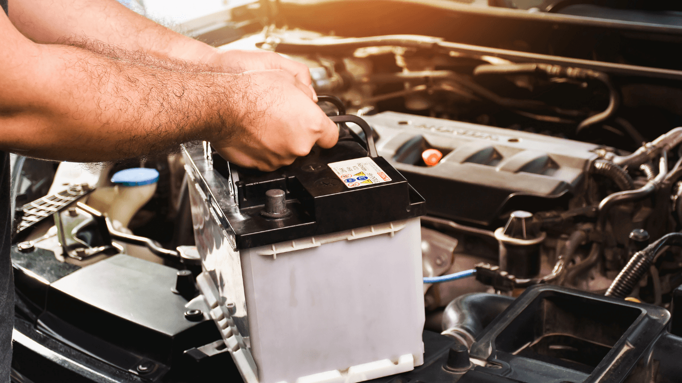 A mechanic doing a battery replacement.