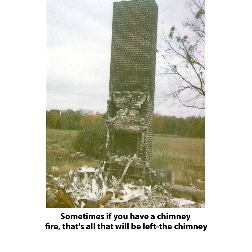Burned brick chimney standing alone in a field, with debris at the base and caption text below