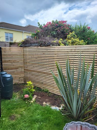 A wooden deck is being built in a backyard.