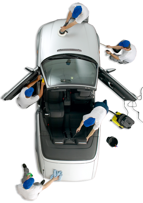 A group of people are cleaning a car with a vacuum cleaner.