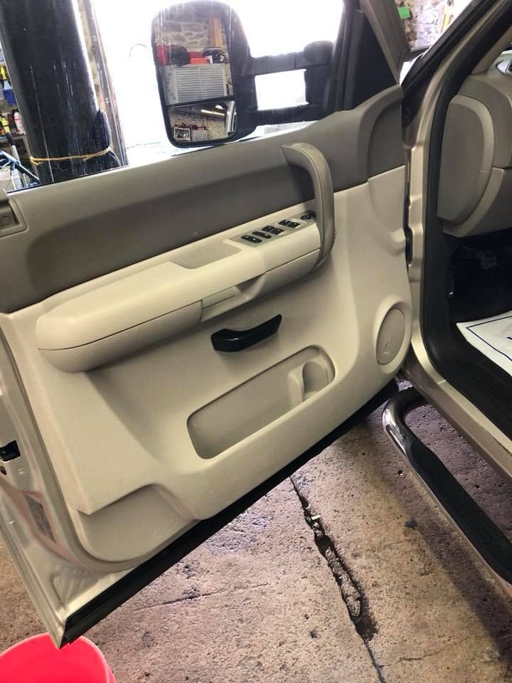 A close up of a car door with the door open.