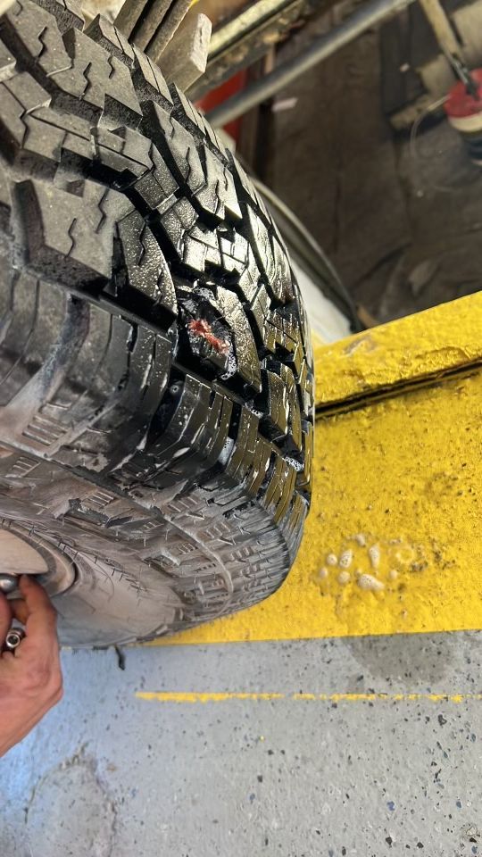 A close up of a tire with a hole in it.