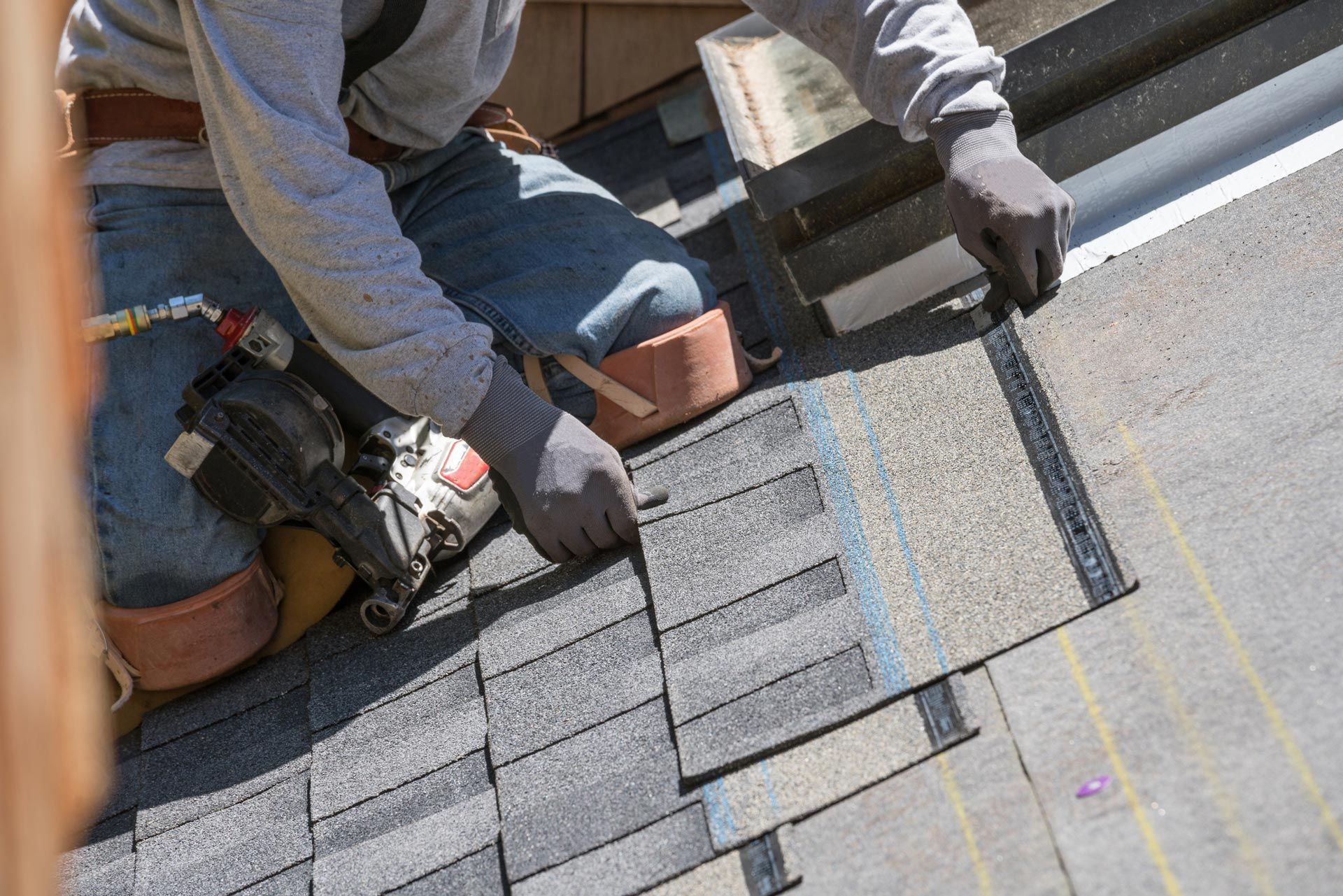 Men installing new shingle roof