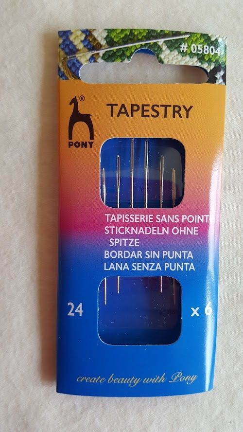 Package of blue and gold tapestry sewing needles, size 24, with six needles visible through windows