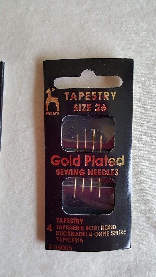 Black package of gold-plated tapestry sewing needles, size 26, with a clear front window.