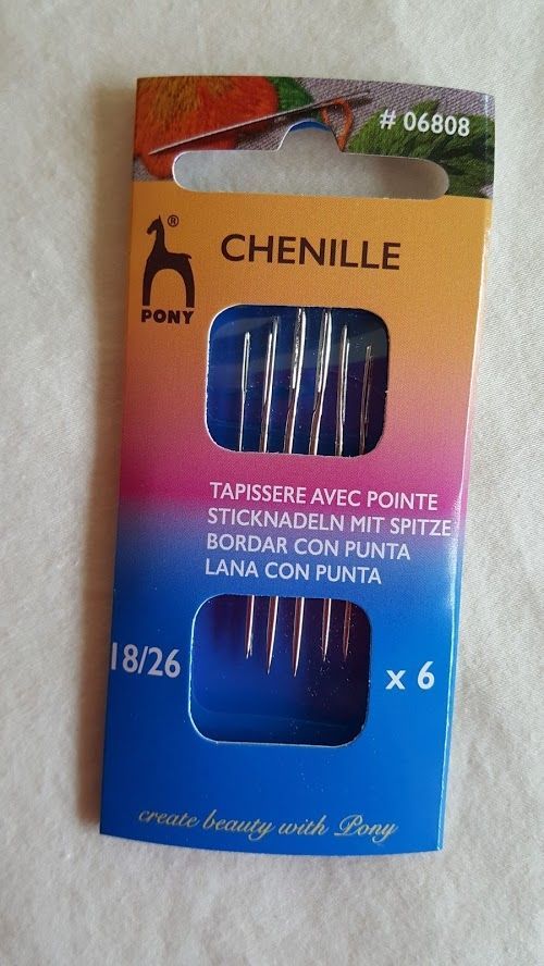 Orange-blue package of CHENILLE pont knitting needles with a clear window showing blue needles.