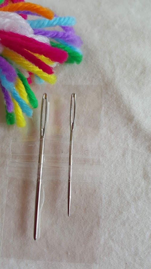 Package of assorted knitting needles, blue and orange, labeled “Knitter’s Needles” and “x2”