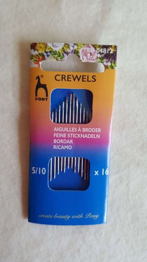 Orange and blue crewel needles pack with floral top and “x16” label