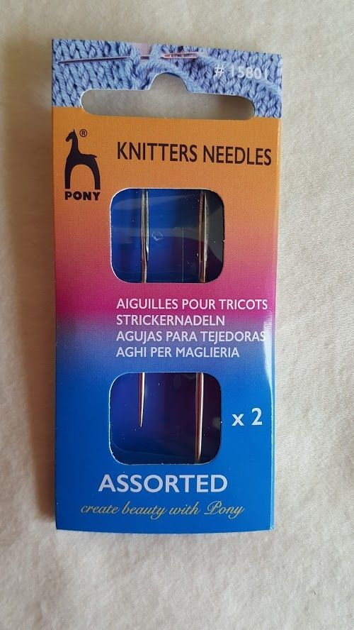 Package of assorted knitting needles, blue and orange, labeled “Knitter’s Needles” and “x2”