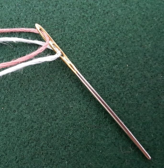 Package of size 15, 17, 20 double-eyed tapestry needles on an orange-blue card
