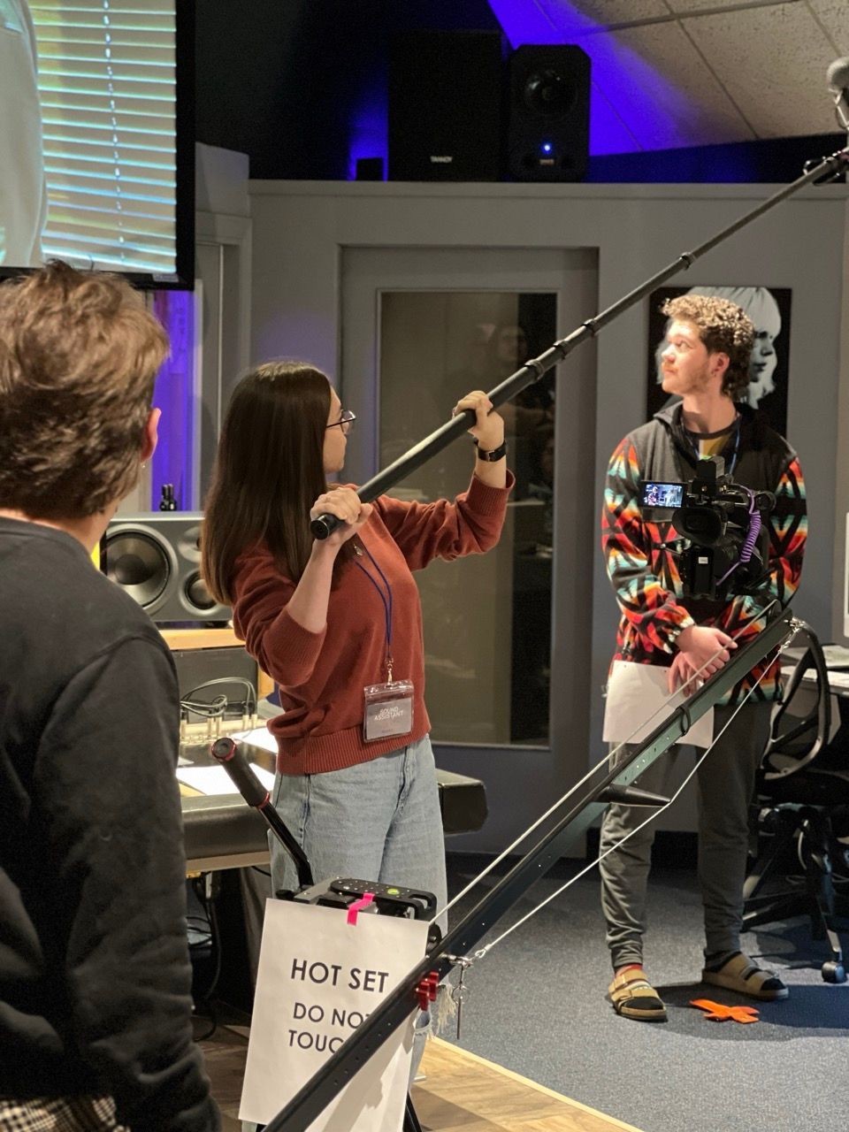 A man and a woman are standing in a room with a sign that says not set do not touch
