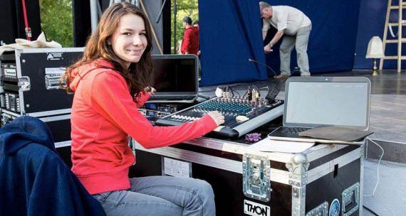 Ana Popa is sitting at a desk with a laptop and a mixer.