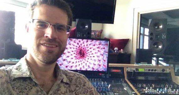 Art Mullin wearing glasses is standing in front of a computer monitor.