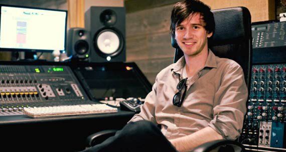 Calvin Hartwick is sitting in a chair in a recording studio.