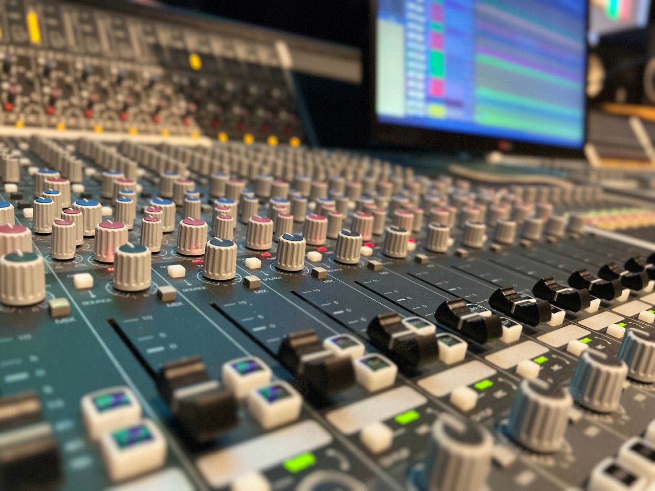 A mixer with a lot of knobs and buttons on it