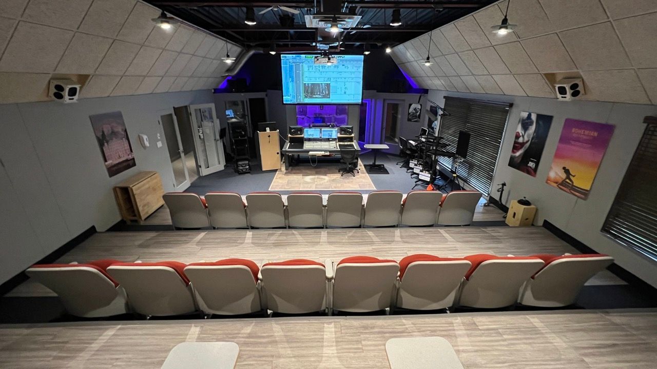 A large room with a lot of seats and a projector screen.
