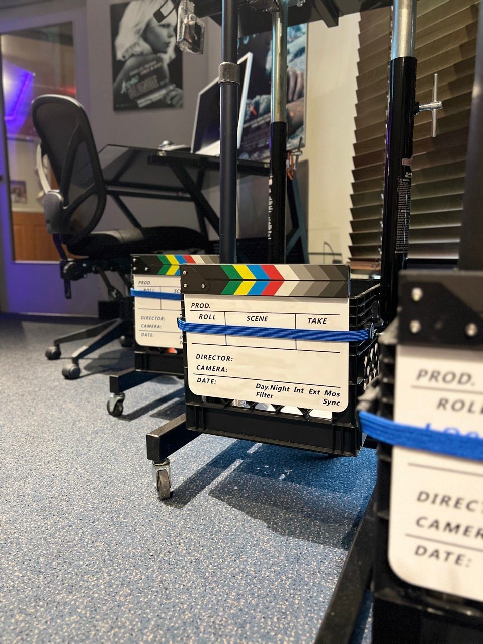 A row of clapper boards are lined up in a room