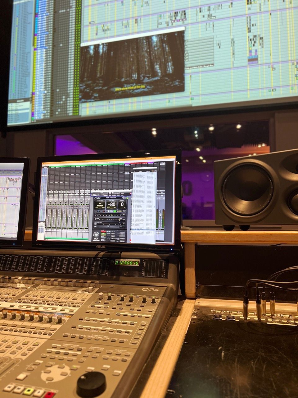 A recording studio with monitors and a mixer
