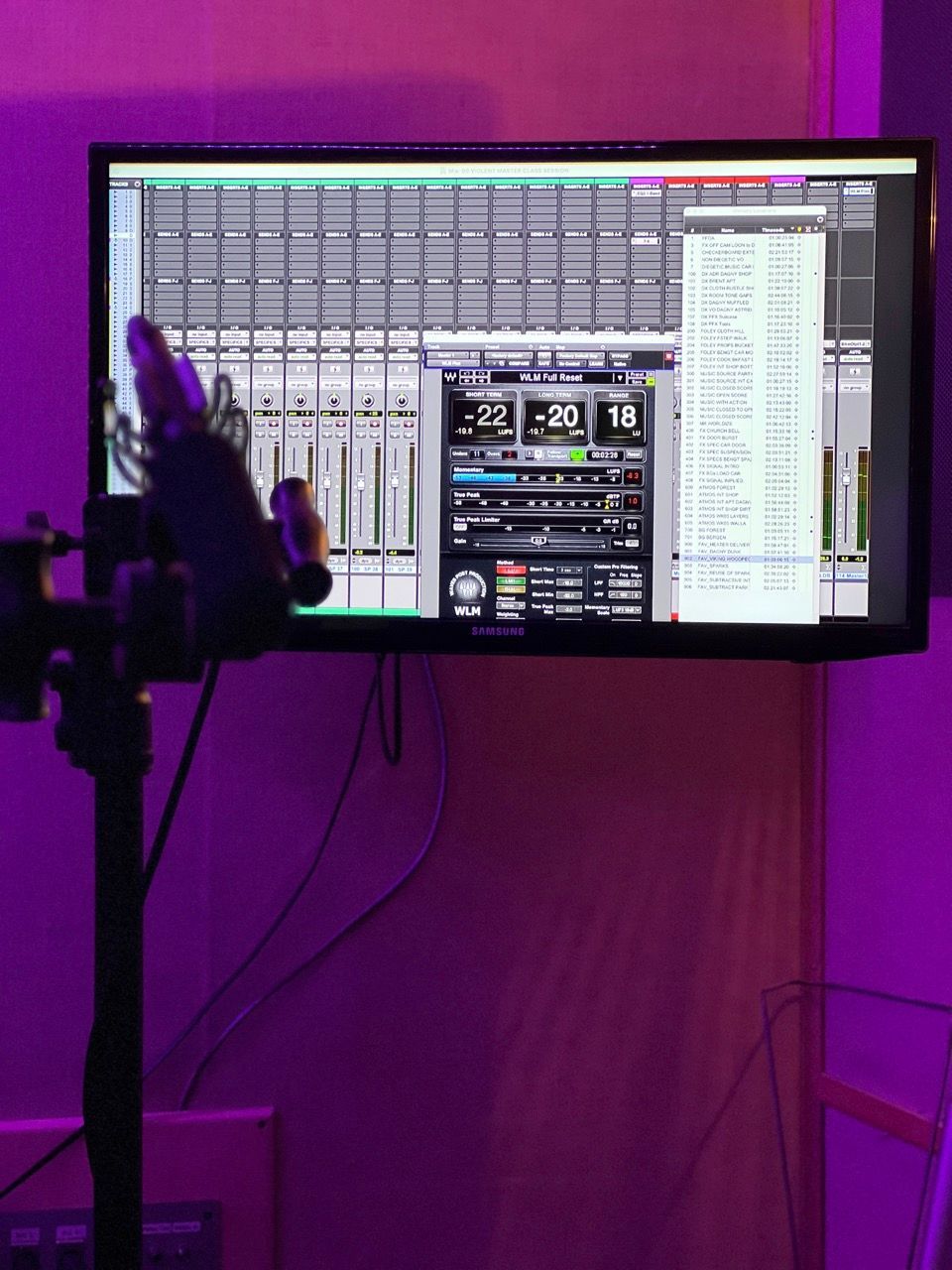 A computer monitor with a purple light behind it