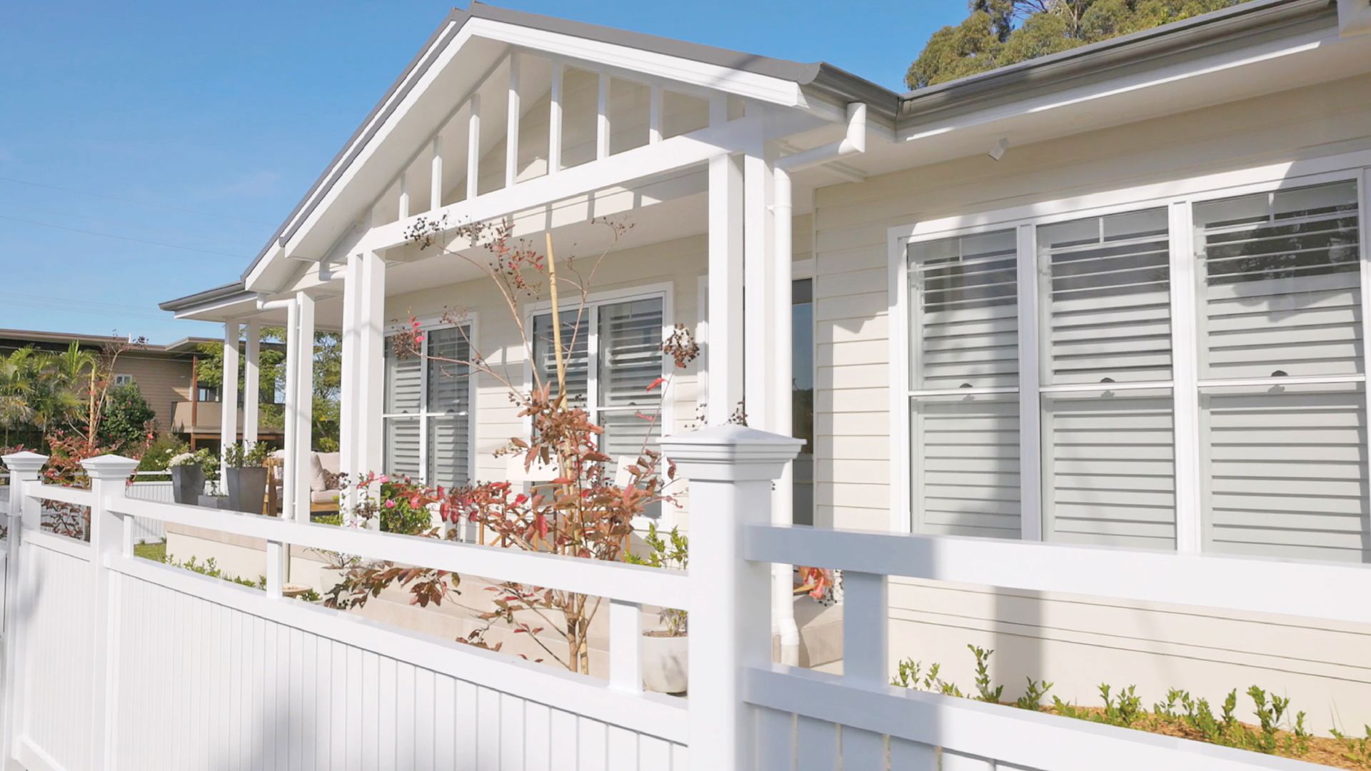 White House With a Gabled Roof and a White Picket Fence on a Sunny Day — Evolution Building Group Dapto, NSW