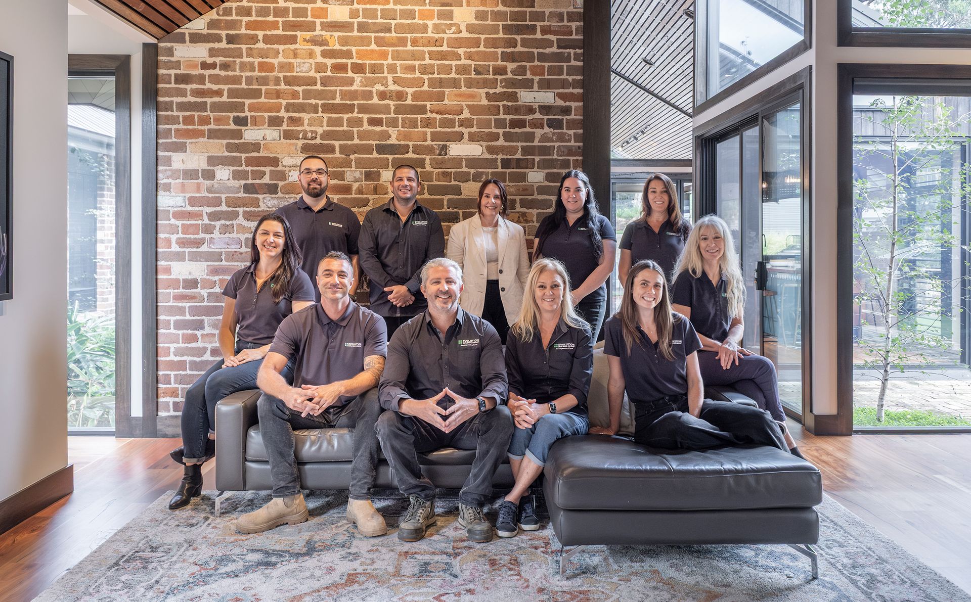 a team are gathered smiling for the photo — Evolution Building Group Dapto, NSW