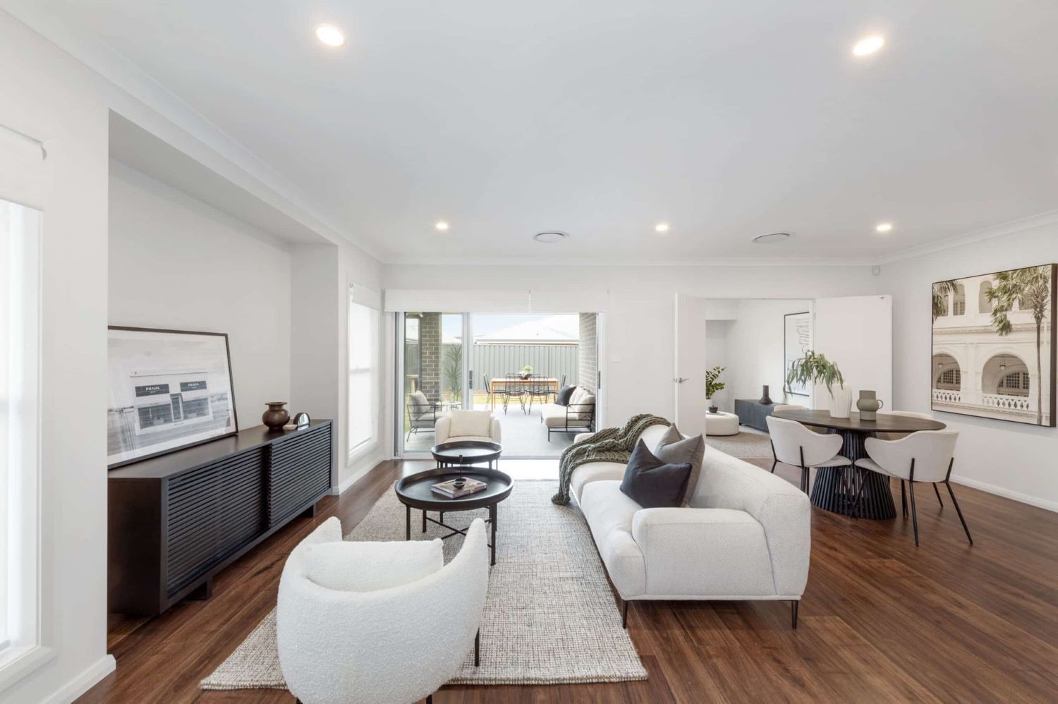 A Living Room with A White Couch, Chairs, and A Table — Evolution Building Group Dapto, NSW