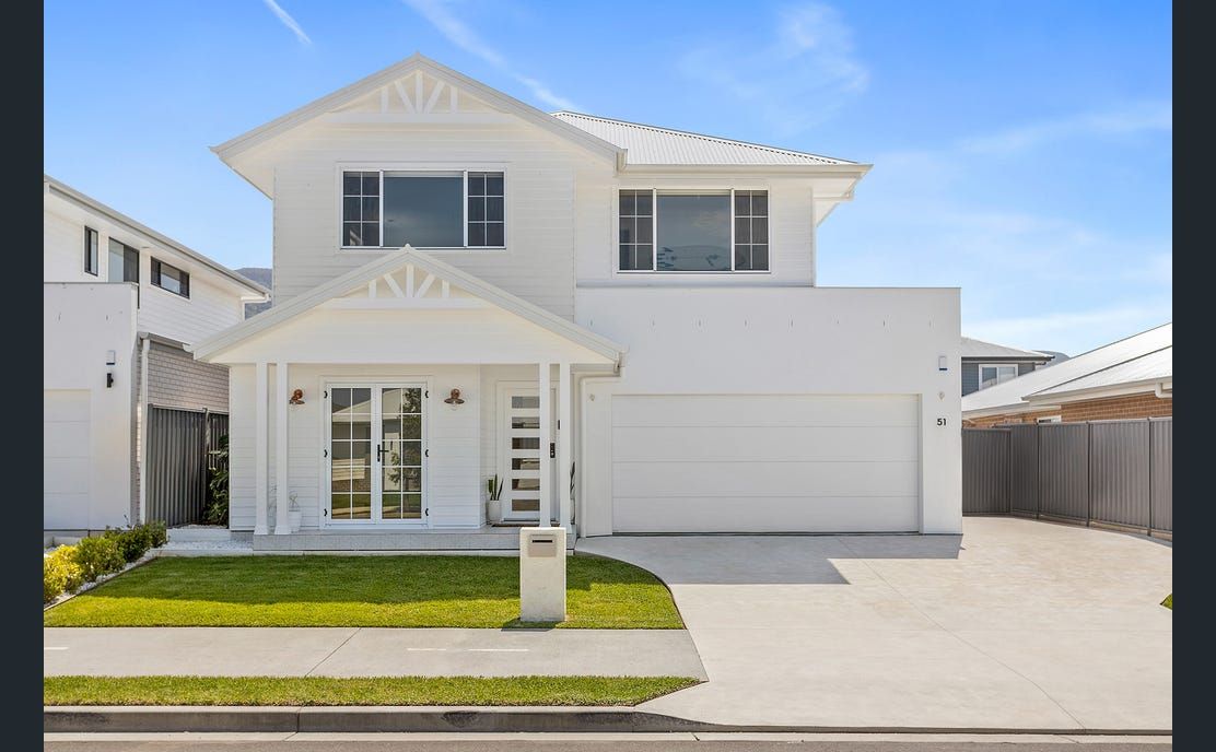 White Two-story House With a Garage and Lawn — Evolution Building Group in Wollongong, NSW