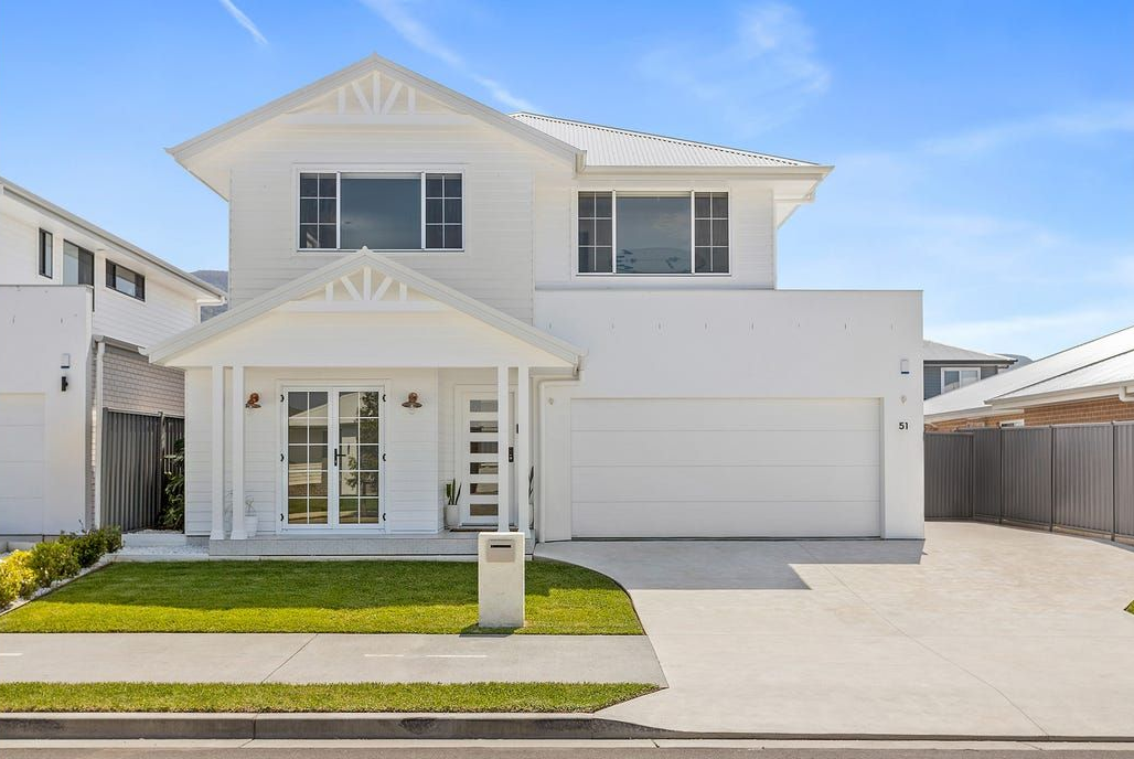 White Two-Story House With a Garage and Lawn — Evolution Building Group in Dapto, NSW
