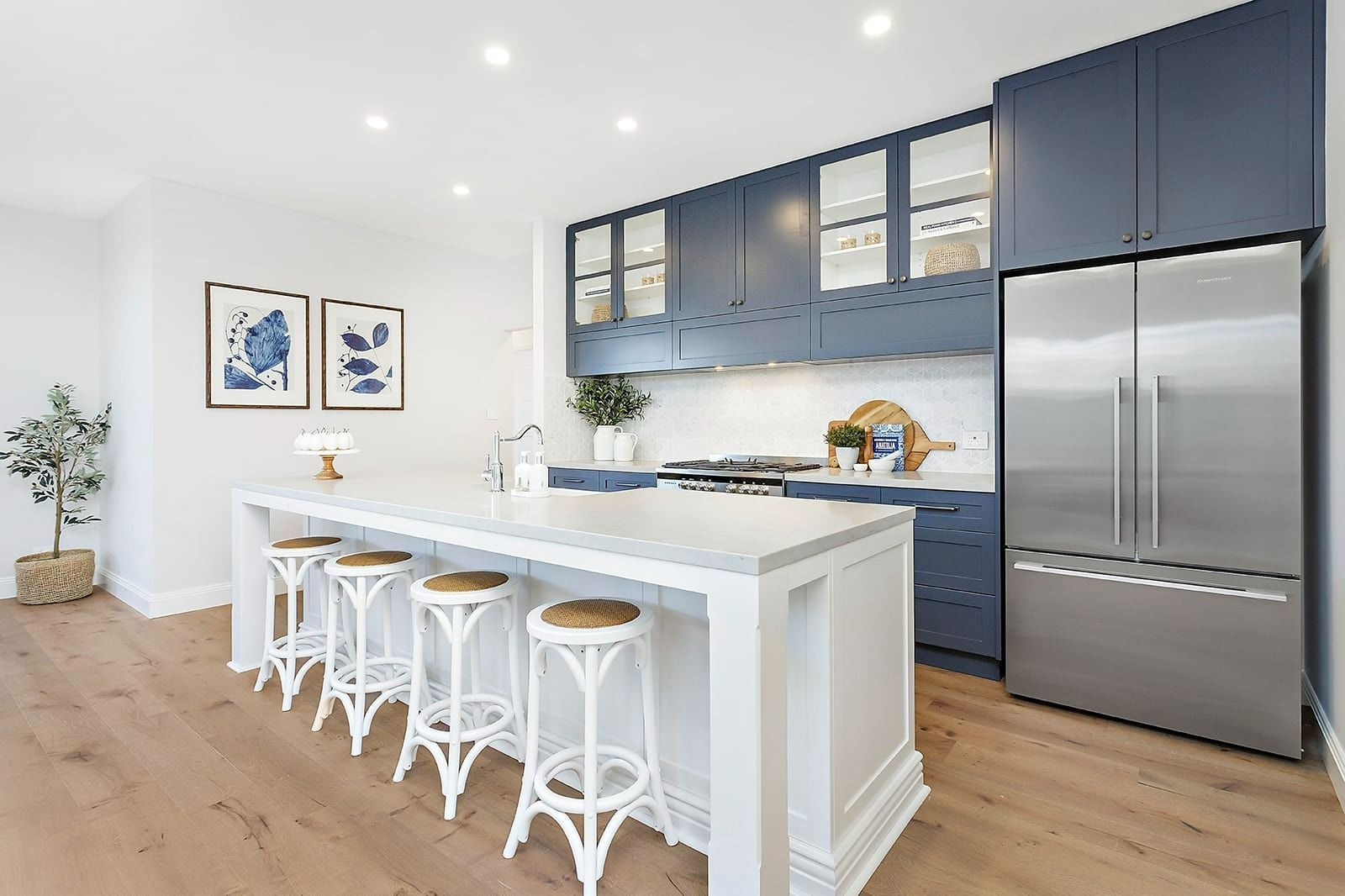 A Kitchen with Blue Cabinets, Stainless Steel Appliances and A Large Island — Evolution Building Group In Illawarra, NSW