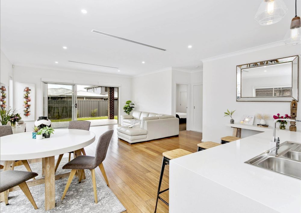 A Living Room and Dining Room in a House With a Table and Chairs — Evolution Building Group Dapto, NSW