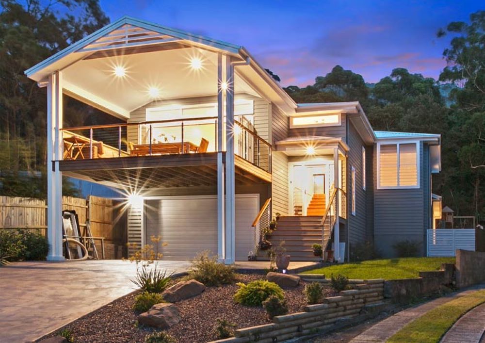 A House with A Balcony and Stairs Is Lit up At Night — Evolution Building Group Dapto, NSW