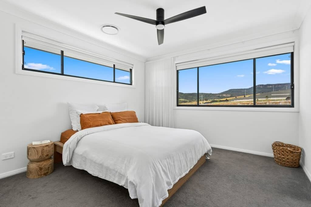 A Bedroom with A Large Bed and A Ceiling Fan — Evolution Building Group In Illawarra, NSW