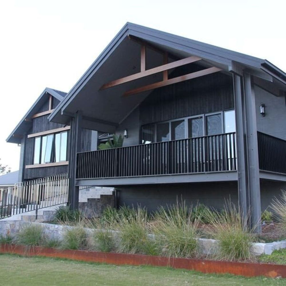A Large House with A Balcony on The Side of It — Evolution Building Group Dapto, NSW