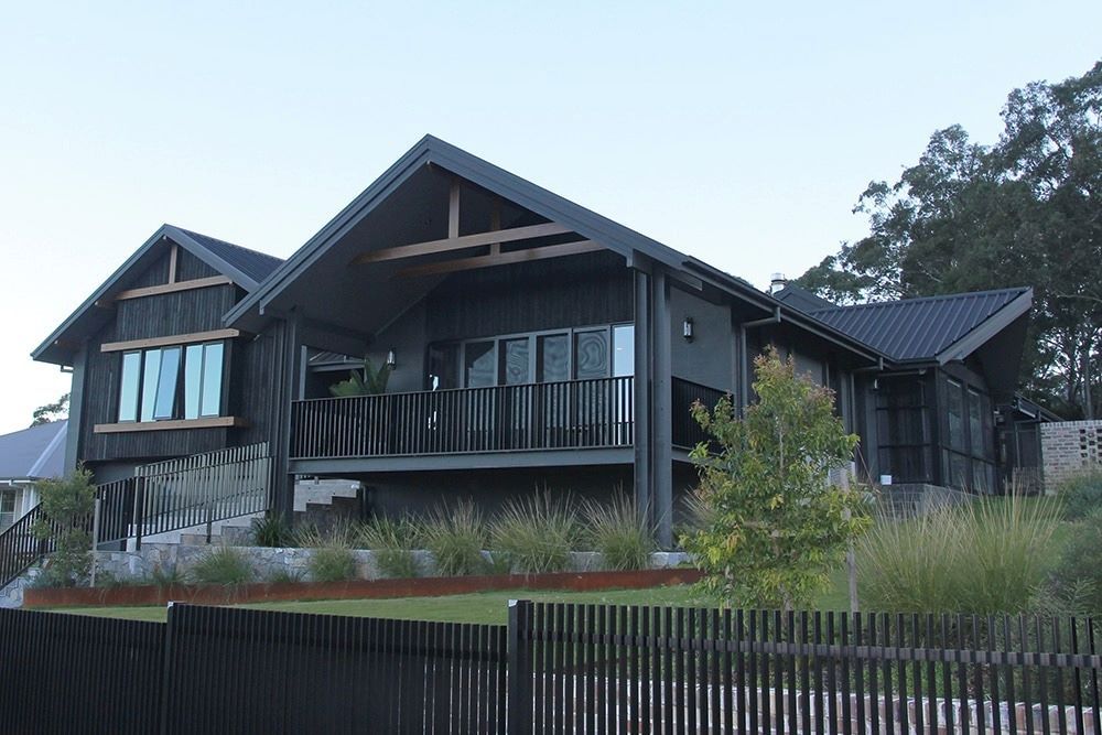 A Large House with A Fence in Front of It — Evolution Building Group Dapto, NSW